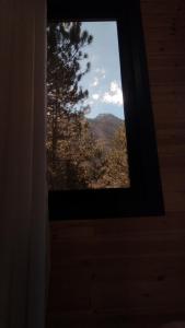 a window in a room with a view of a mountain at Vruçaj' s Cabin in Bogë