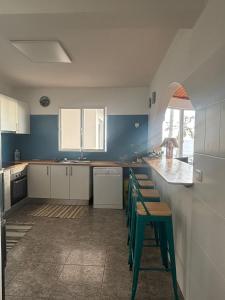 a kitchen with blue and white cabinets and a counter at Lucky Jack in Jardim do Mar +25 photos