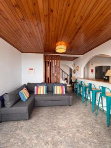 a living room with a couch and blue chairs at Lucky Jack in Jardim do Mar