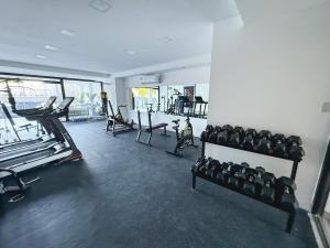 a gym with rows of exercise equipment in a room at Aura Urbana Apartment in San Juan