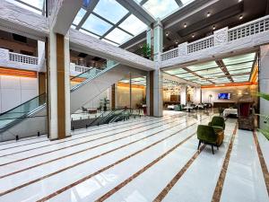 an empty lobby with escalators in a building at National Hotel Ganja in Ganja +76 photos