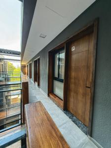 a hallway with a bench and a wooden door at Aura Urbana Apartment in San Juan