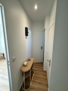 a small room with a small table and a tv at Manava Etretat Sea ViewHouse in Étretat +13 photos