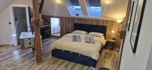 a bedroom with a large bed with a blue frame at URBAN APARTHOTEL Medias in Mediaş