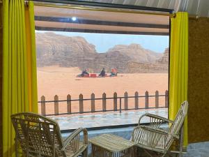 a room with chairs and a view of the desert at Hillawi Private Desert Camp in Aqaba