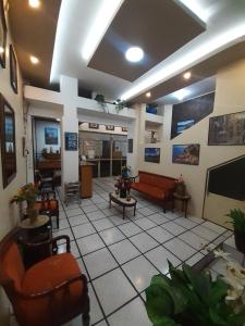 a living room with couches and chairs in a room at Hotel Central in Latacunga