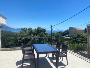 a table and chairs on a balcony with a view at Stone Villa in Zagrađe