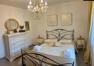 a bedroom with a bed and a mirror and a chandelier at Il Refolo in Norcia +39 photos