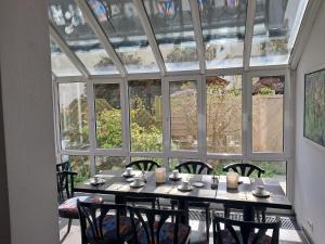 a dining room with a table and chairs and a large window at Gästehaus Linde, Hotel garni in Konstanz