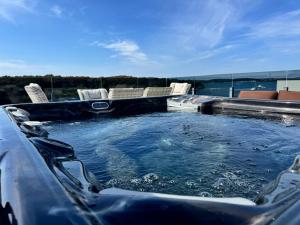 a hot tub with chairs in the back at Apartman Moonlight Medulin in Medulin