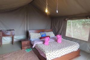 a bedroom with a bed in a tent at Odupoi Lodge in Maji Moto