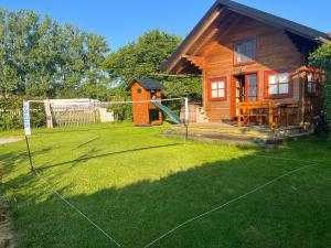 a house with a yard with a playground at Srub u Hadiny in Pelhřimov