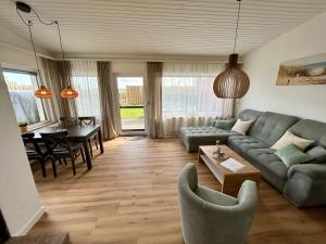 a living room with a couch and a table at SielundMeer in Neuharlingersiel