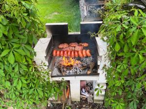 a grill with a bunch of sausages and meat on it at Srub u Hadiny in Pelhřimov