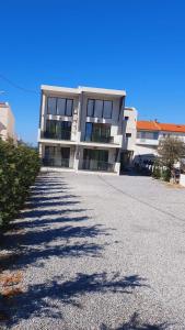 a large white building with a driveway in front of it at Sunny Beach Potos in Potos +86 photos