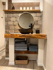 a bathroom with a vanity with a mirror and towels at Pothuis Zuid in Zandvoort +40 photos