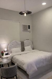 a bedroom with a large bed and a table at استديو بتصميم سينمائي in Buraydah
