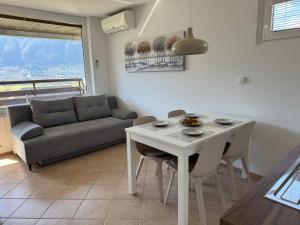 a living room with a table and a couch at Apartment Planika Bovec in Bovec +12 photos
