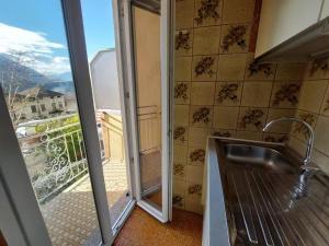 a kitchen with a sink and a sliding glass door at Agata Agnese Homes in Carlazzo