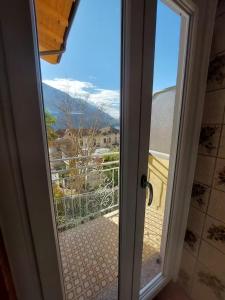 a door open to a balcony with a view at Agata Agnese Homes in Carlazzo