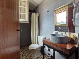 a bathroom with a sink and a toilet at Pousada Memórias de Minas in Ouro Preto