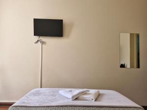 a bedroom with a bed with a television on the wall at Pousada Memórias de Minas in Ouro Preto +76 photos
