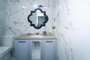 a white bathroom with a sink and a toilet at Lagoon View Holiday Home in Montego Bay +21 photos