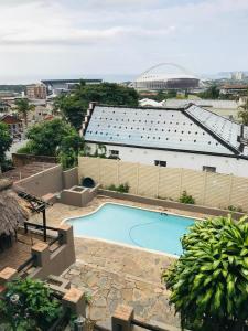 an overhead view of a swimming pool in front of a building at Corfield in Durban