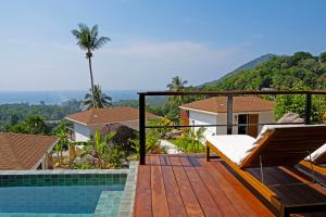 a wooden deck with a bed and a swimming pool at Secret Garden Eco Pool Villas in Ko Tao