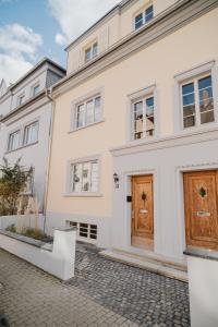 a large white house with a wooden door at Boho - Suites I BRIGHT-Collection in Koblenz
