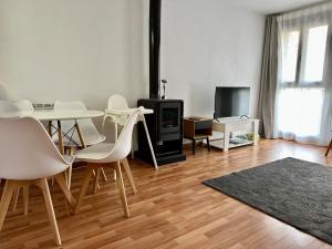 a living room with a table and chairs and a tv at Valdelinares 365 in Valdelinares