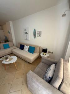 a living room with two couches and a table at Aldi APARTMENTS in Lezhë +1 photo