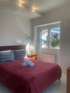 a bedroom with a large bed with a red blanket at Belas Rustic Chick in Belas +71 photos
