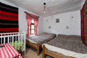 a bedroom with two beds and a window at Kmetova Bajka in Janja +36 photos