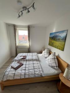 a bedroom with a bed with a blanket and a window at Caldener Hof in Calden