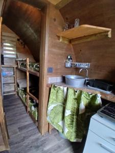 a kitchen in a tiny house with a sink at La Colline Aux Cabanes in Espaly-Saint-Marcel