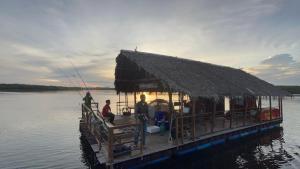 a boat with a straw roof on the water at Krabi Floating Glamping in Ban Khlong Khae (2) +6 photos