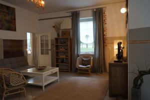 a living room with a couch and a table at Thula - Apartment in Villa Ambrosian in Trzebież