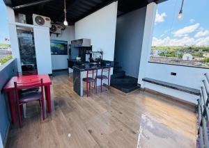 a kitchen with a red table and stools at La Casa D Juan in Puerto Baquerizo Moreno