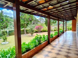 a porch with a view of a garden at Recanto MJ in Campos do Jordão