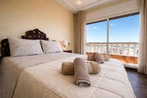 a bedroom with a large bed with a large window at Luxury Villa, 3 Levels, 5 bedrooms, 5 Baths, Pool & Garden in Tétouan