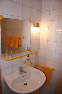 a bathroom with a sink and a mirror and towels at Landhaus am Esch in Warendorf +35 photos
