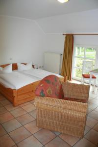 a bedroom with a bed and a chair and a couch at Landhaus am Esch in Warendorf
