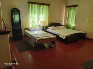 a bedroom with two beds and a mirror at Gleanloch Holiday Resort in Tawalantenna +9 photos