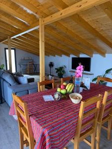 a dining room table with a bowl of fruit on it at Casa da Quinta in Estreito da Calheta