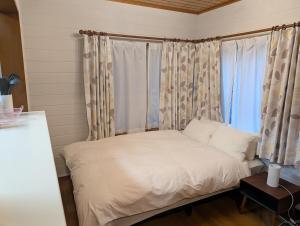 a bed in a room with a window at Seasiders in Ichinomiya +17 photos