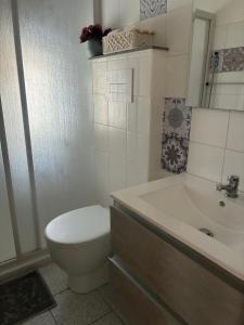 a bathroom with a toilet and a tub and a sink at Guest House Oleandro in Santa Maria Navarrese +124 photos