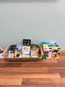a basket of food and snacks on a table at Clover Road Guest Suite in Swaffham