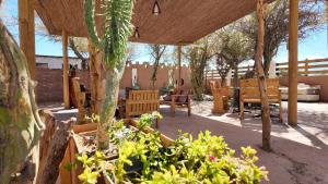 a patio with a table and chairs and a tree at El Rancho B&B in San Pedro de Atacama