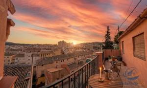 a balcony with a view of a city at sunset at casadelsol in Caravaca de la Cruz